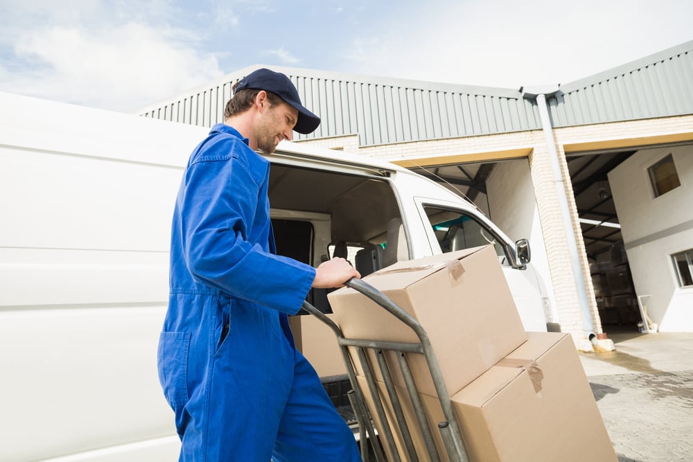 worker unloading goods from a commercial van, guide to commercial vehicle financing