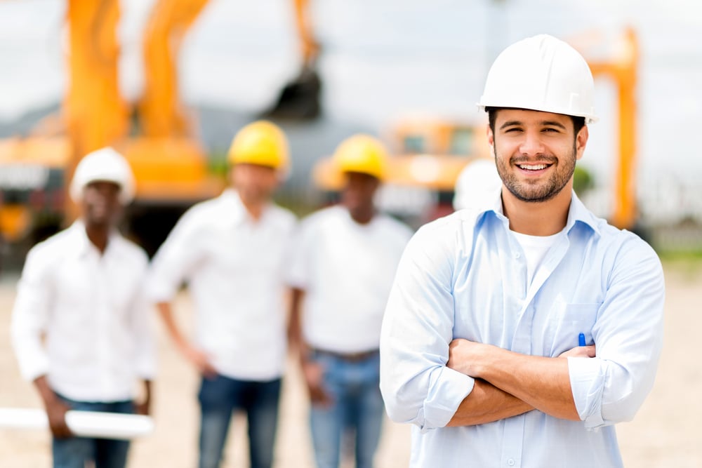 architect at a construction site looking happy, equipment financing