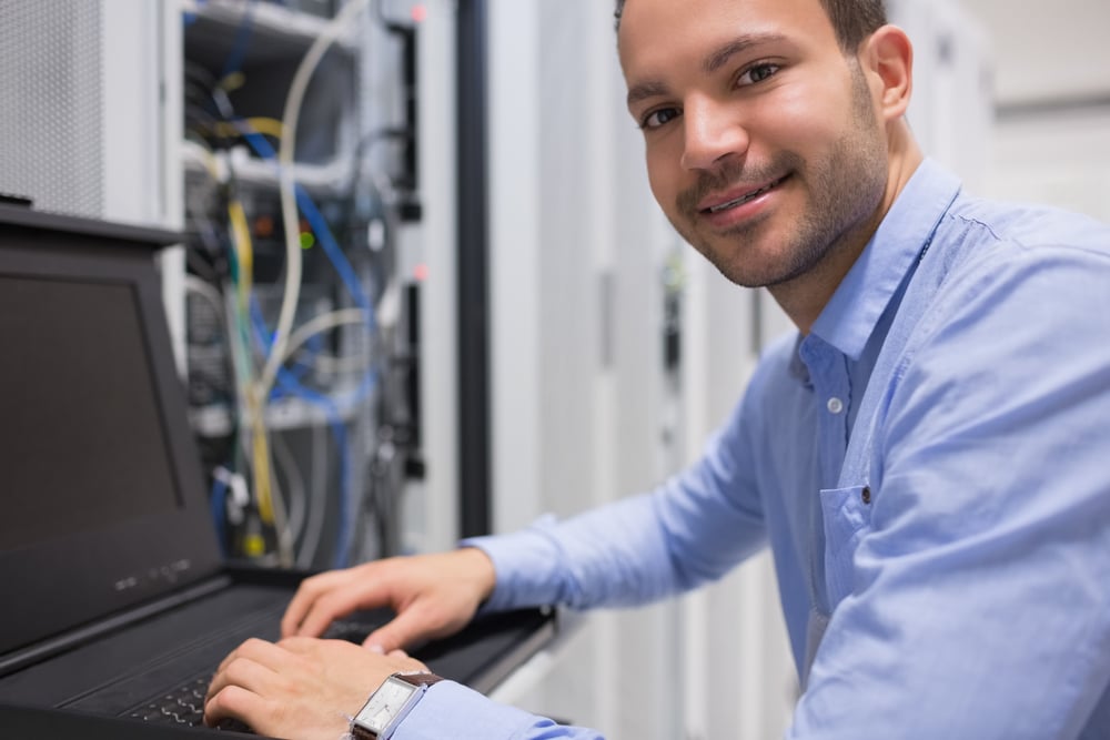 tech worker fixing a server, how To reduce equipment downtime