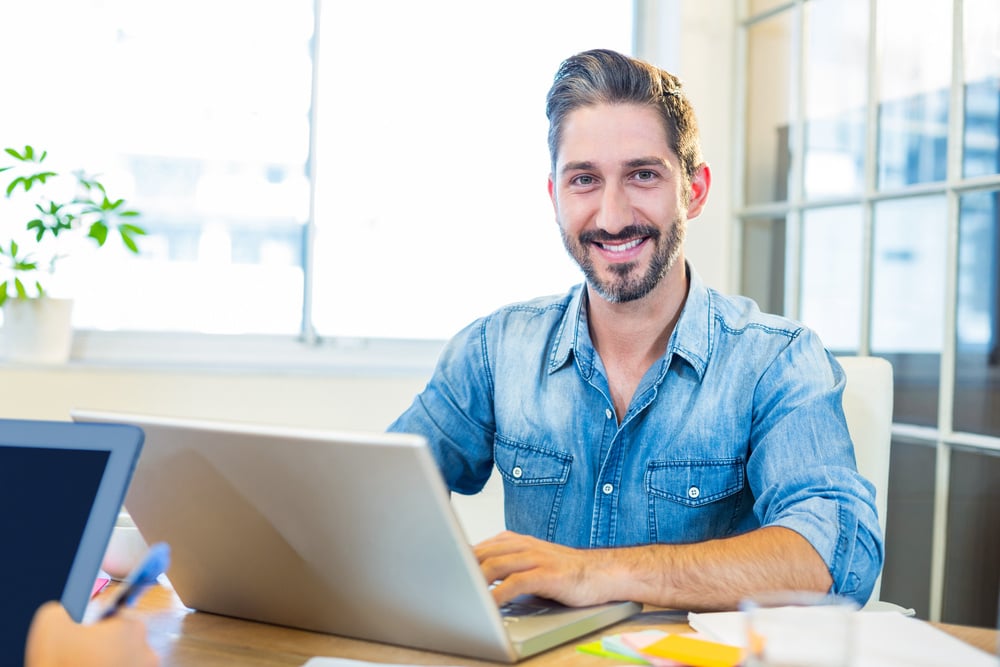 male business owner smiling at desk, section 179 updates for 2025