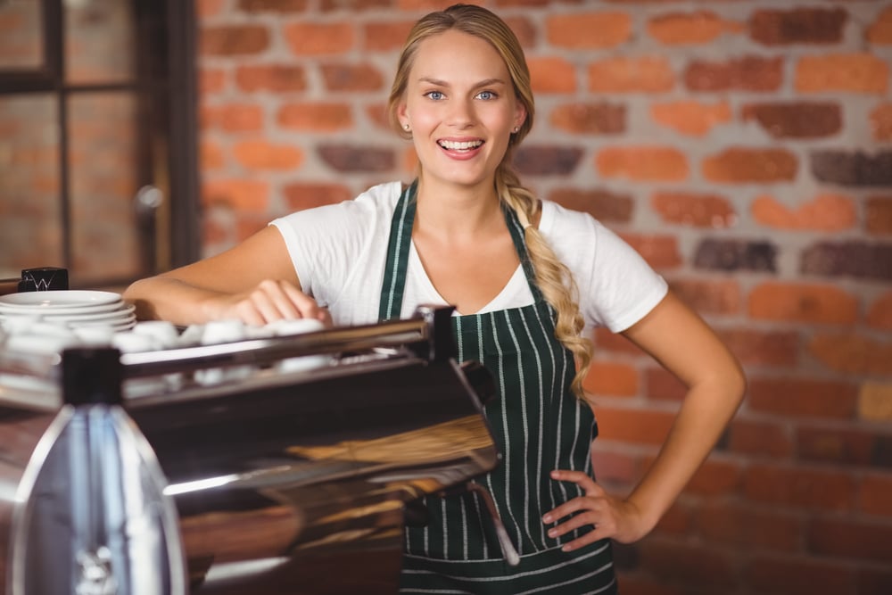 female coffee shop franchise owner smiling, how to fund your franchise