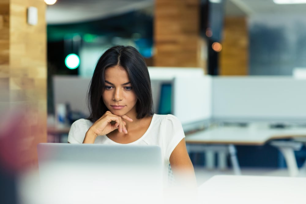 portrait of a serious businesswoman using laptop in office, section 179 calculator