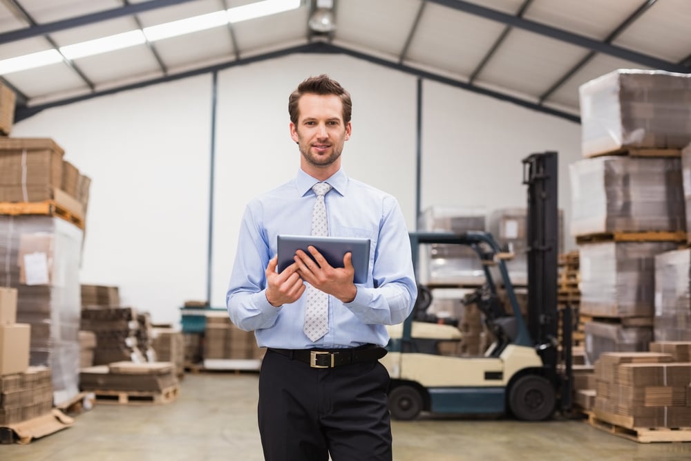 warehouse business owner using tablet, annual business revenue guide