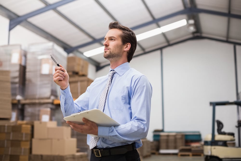 manager holding clipboard in the warehouse, commercial financing