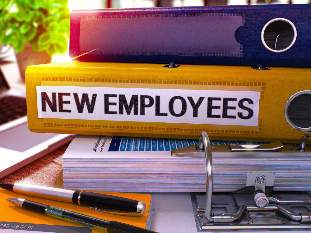 stack of new employee files for small business, how to attract and retain top talent