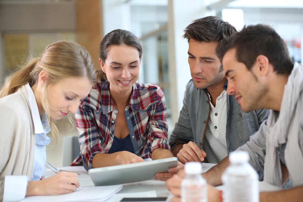 four business employees discussing work strategies, business tips to start the new year right