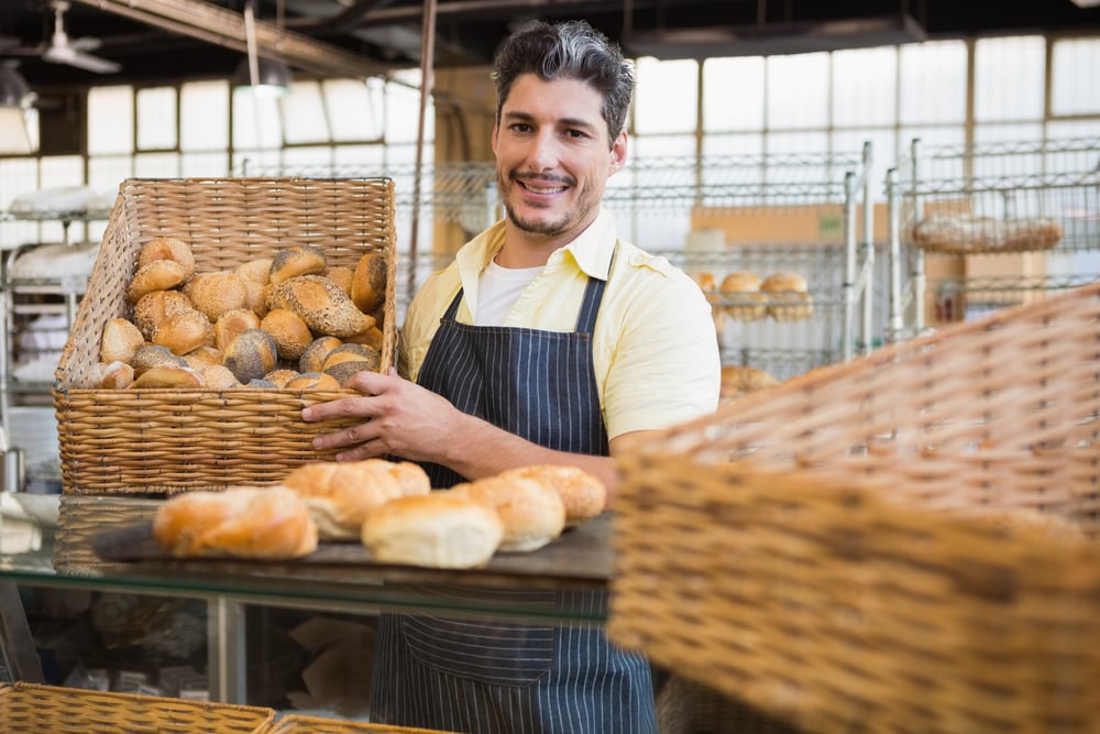 bakery owner with basket of fresh bread rolls, invoice factoring