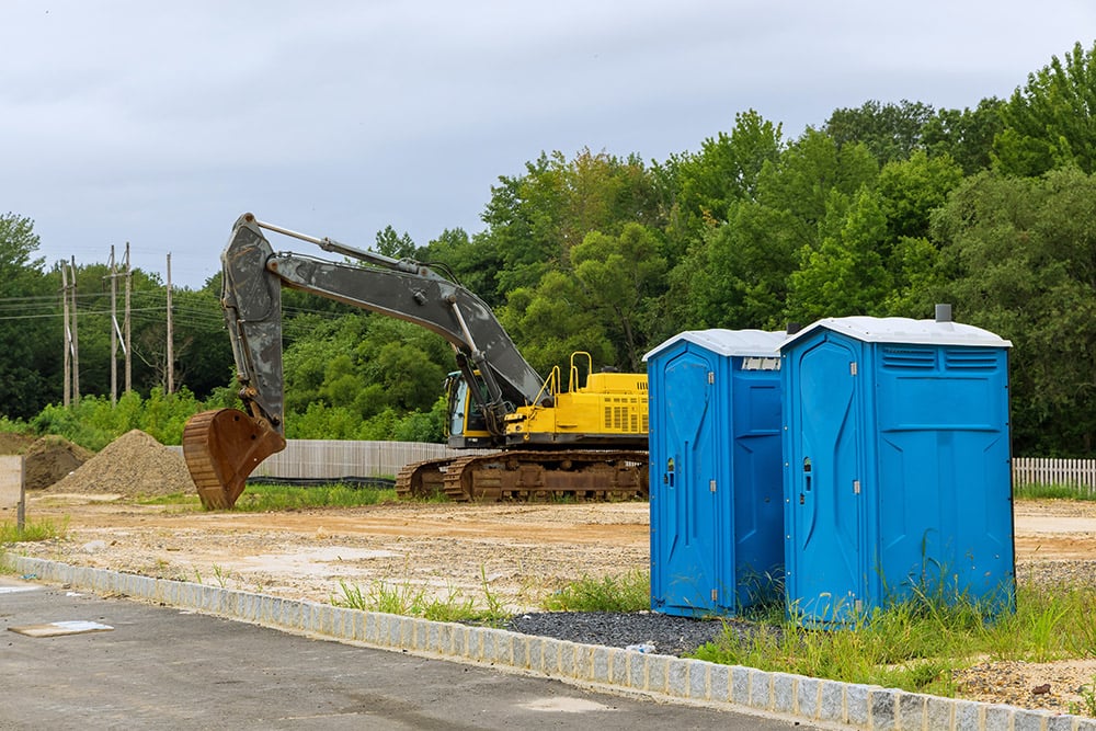 two portable toilets at a construction site, portable sanitation equipment financing
