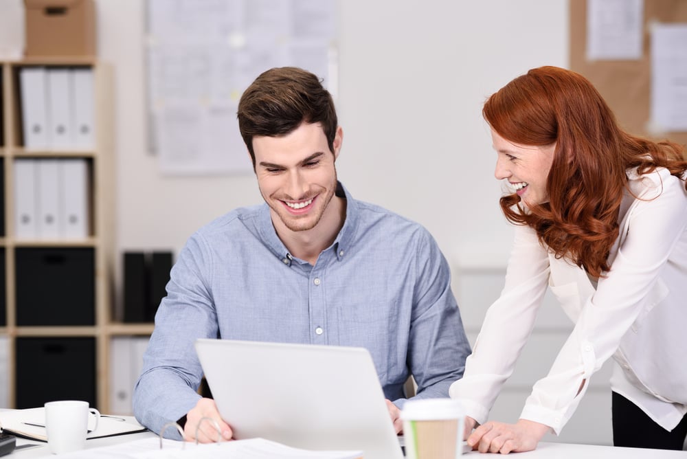 smiling business owners looking at laptop computer, alternative lending for businesses