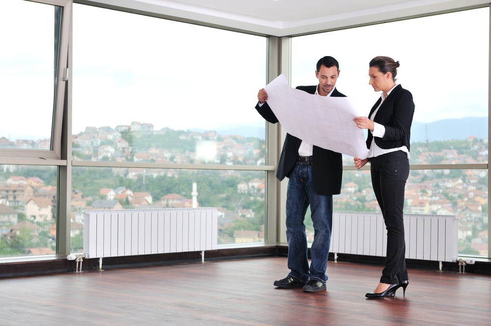 male and female business owners looking at architecture plans, strategies for business expansion