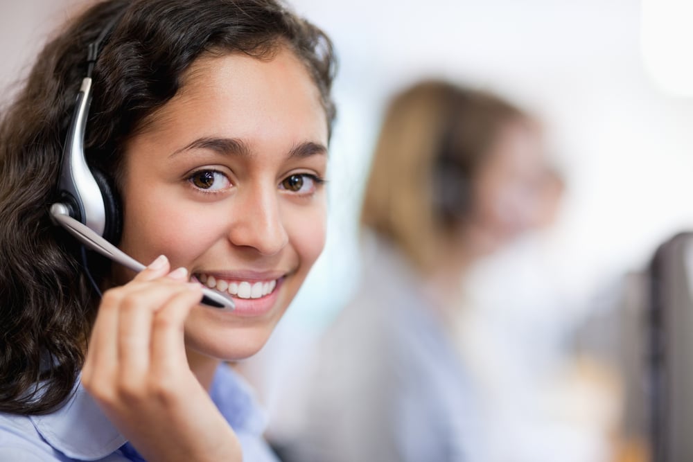 smiling customer service manager on the phone, guide to customer service
