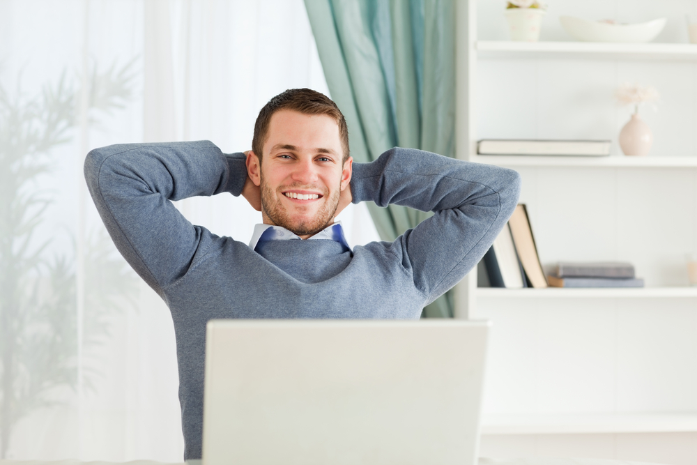smiling businessman in home office, home-based business tax guide