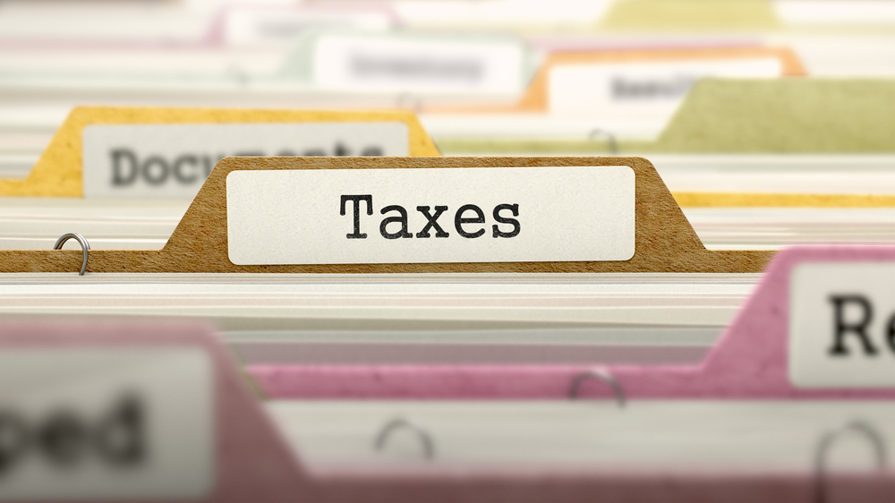 standing files with taxes tab, small business tax deduction guide